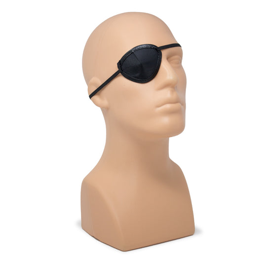 Black eye patch displayed on a beige mannequin head against a plain white background.