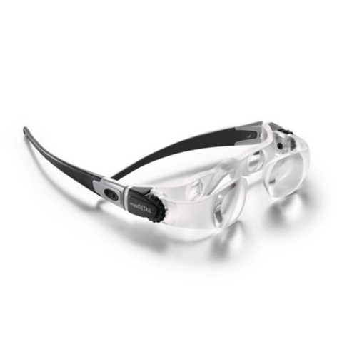 Eschenbach MaxDETAIL magnifying glasses with clear transparent lenses, a black and silver temple arm, and a clear nose bridge, shown on a white background with a soft shadow.