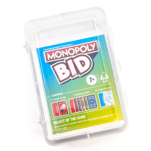 Monopoly Bid card game in a clear plastic storage case, featuring a blue-to-yellow gradient label with the Monopoly Bid logo and contents preview.